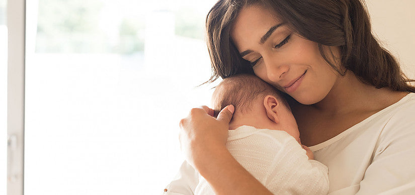 Ein Elternteil hält ein Baby beim Stillen